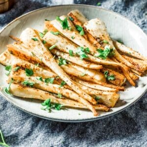 roasted parsnips in a white plate