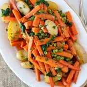 large dish of carrots peas and potaotes