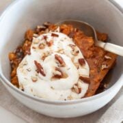 pumpkin baked oatmeal topped with nuts and whipped cream