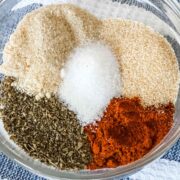 close up of 5 ingredients that make up turkey rub including salt, onion powder, paprika, garlic powder, and sage