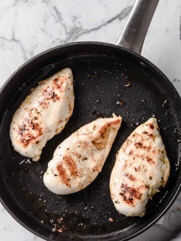 three chicken breasts in a skillet