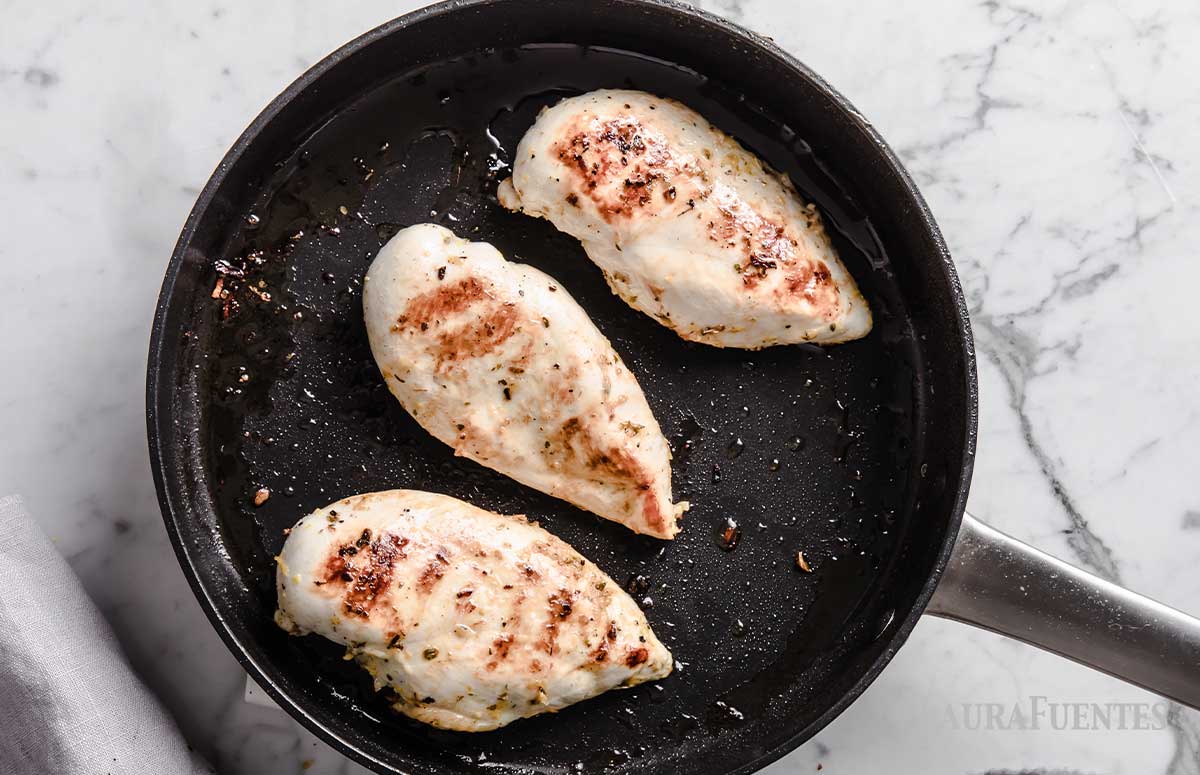 three chicken breasts in a skillet