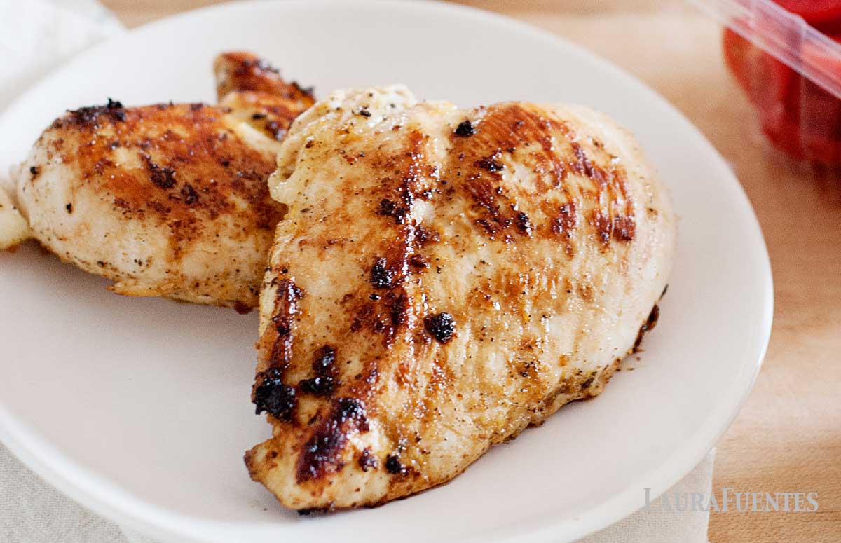 two chicken breasts on a white plate