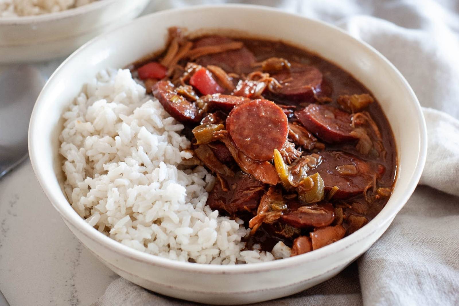 a bowl of chicken gumbo with white rice