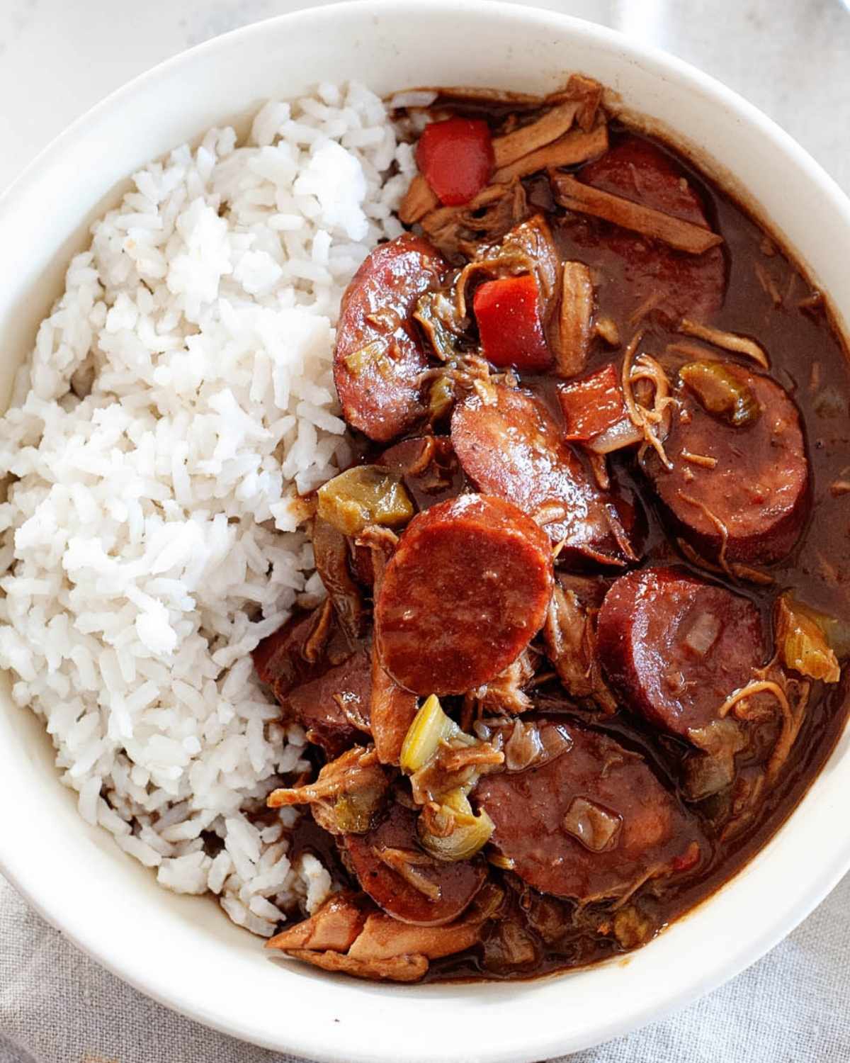 a bowl of chicken gumbo with white rice