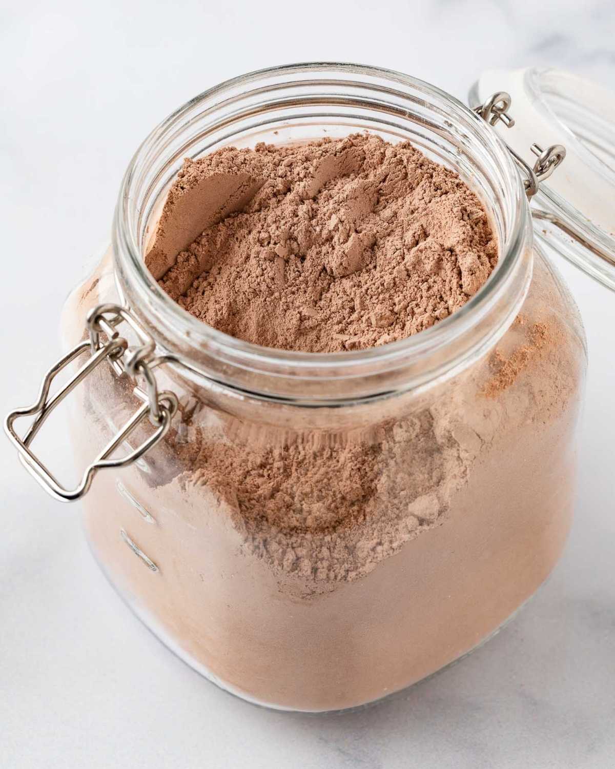 a glass storage container filled with homemade hot cocoa mix