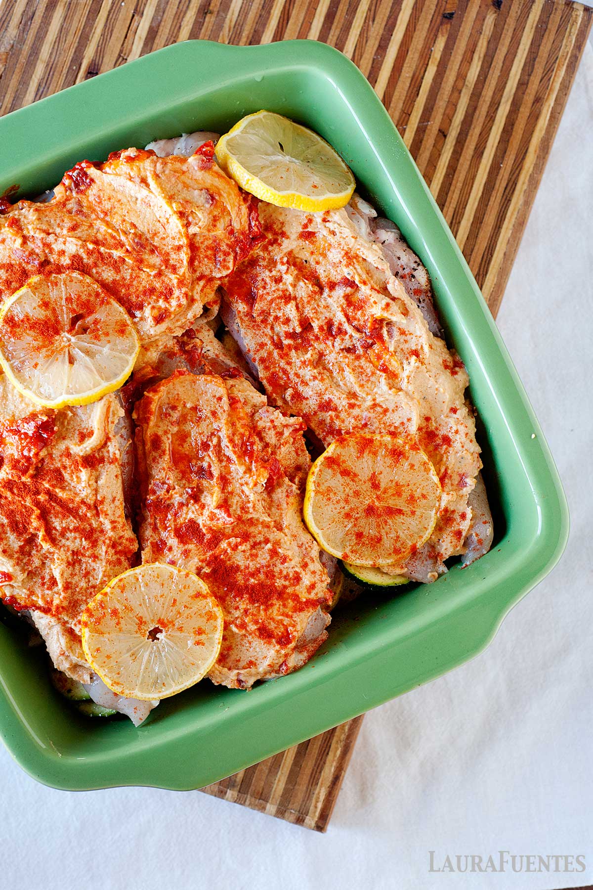 hummus topped chicken in a baking dish