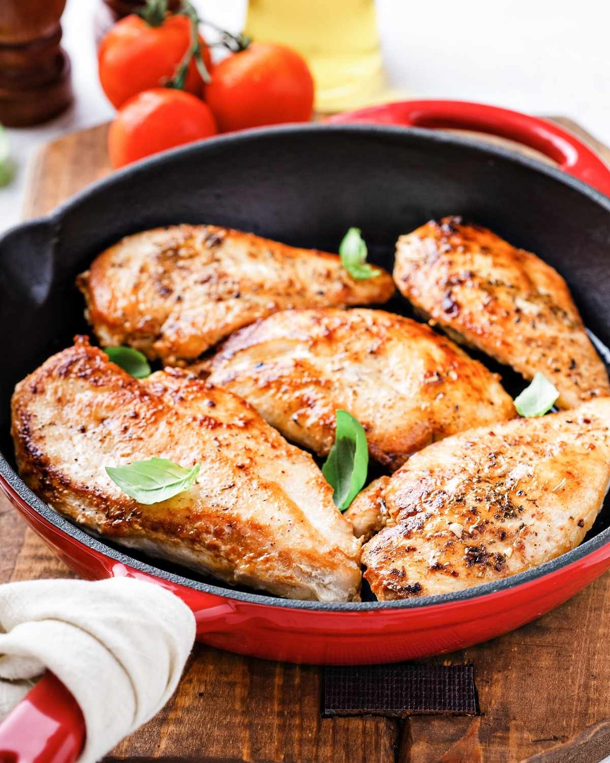 five chicken breasts in a cast iron skillet