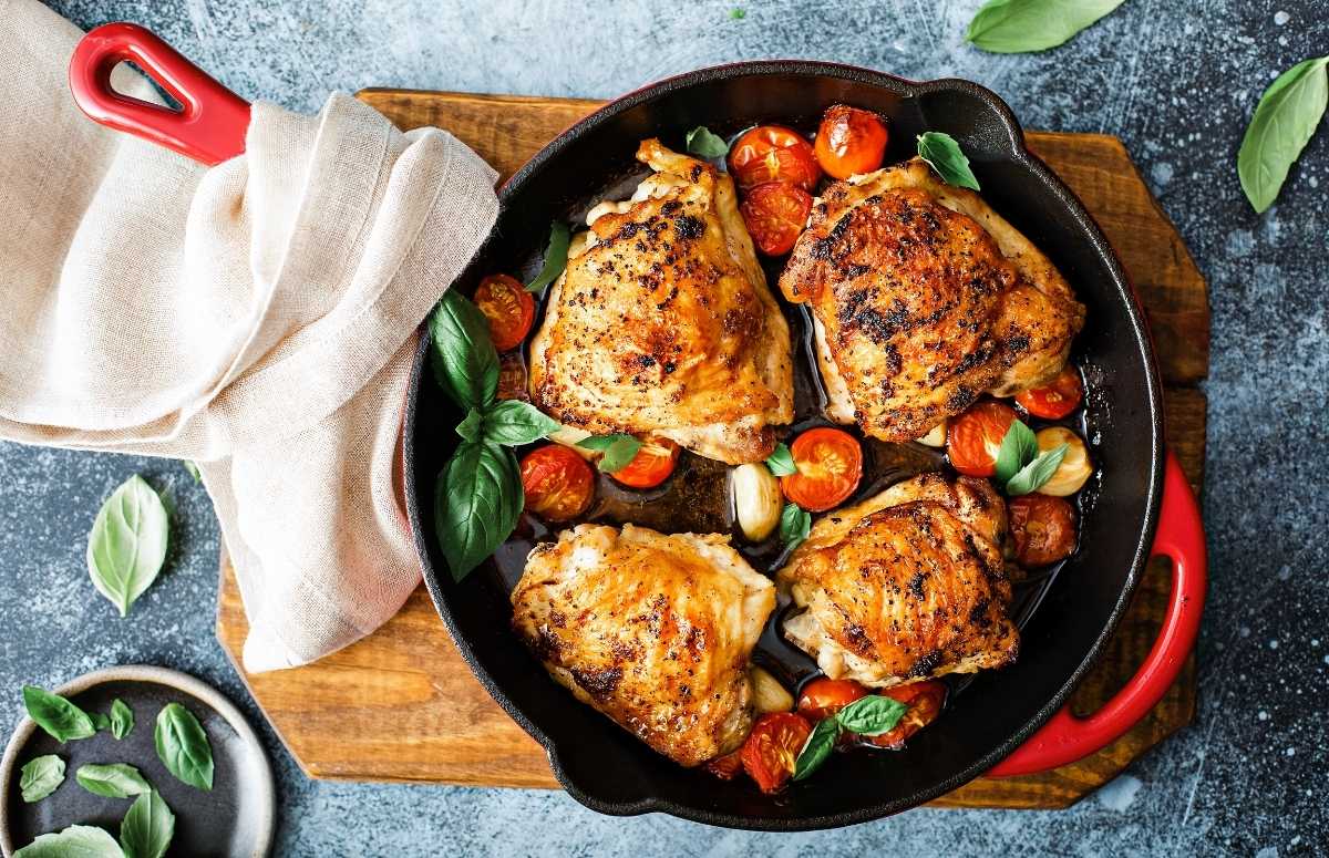 top view of four seared chicken thighs in a pan