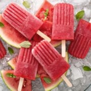 watermelon popsicles over ice and watermelon pieces