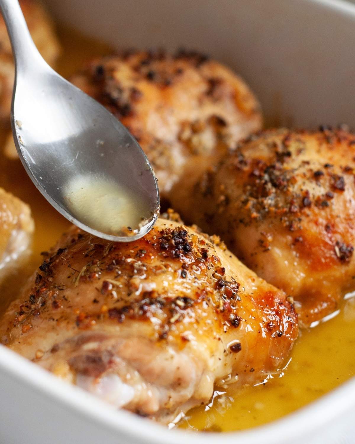 baked chicken thighs in a dish with a spoon