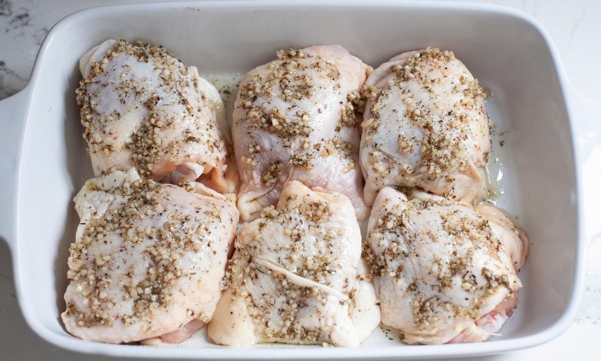 raw chicken thighs with seasoning on them 