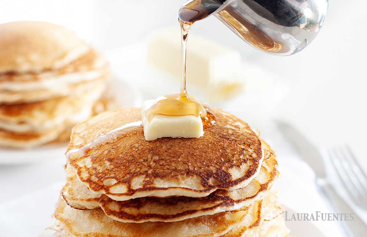 large stack of pancakes with butter on top 