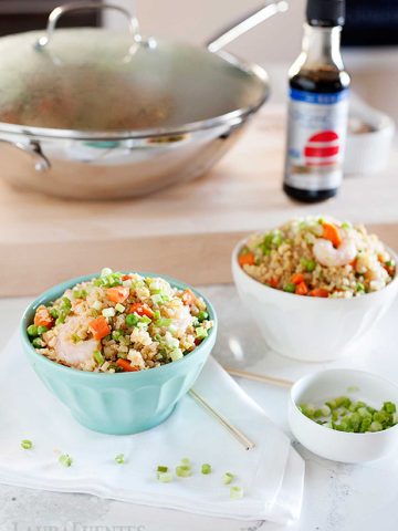 wok of cauliflower fried rice with shrimp. And two small bowls of the same.
