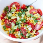 a bowl of corn tomato salad