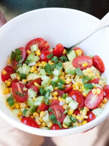 a bowl of corn tomato salad