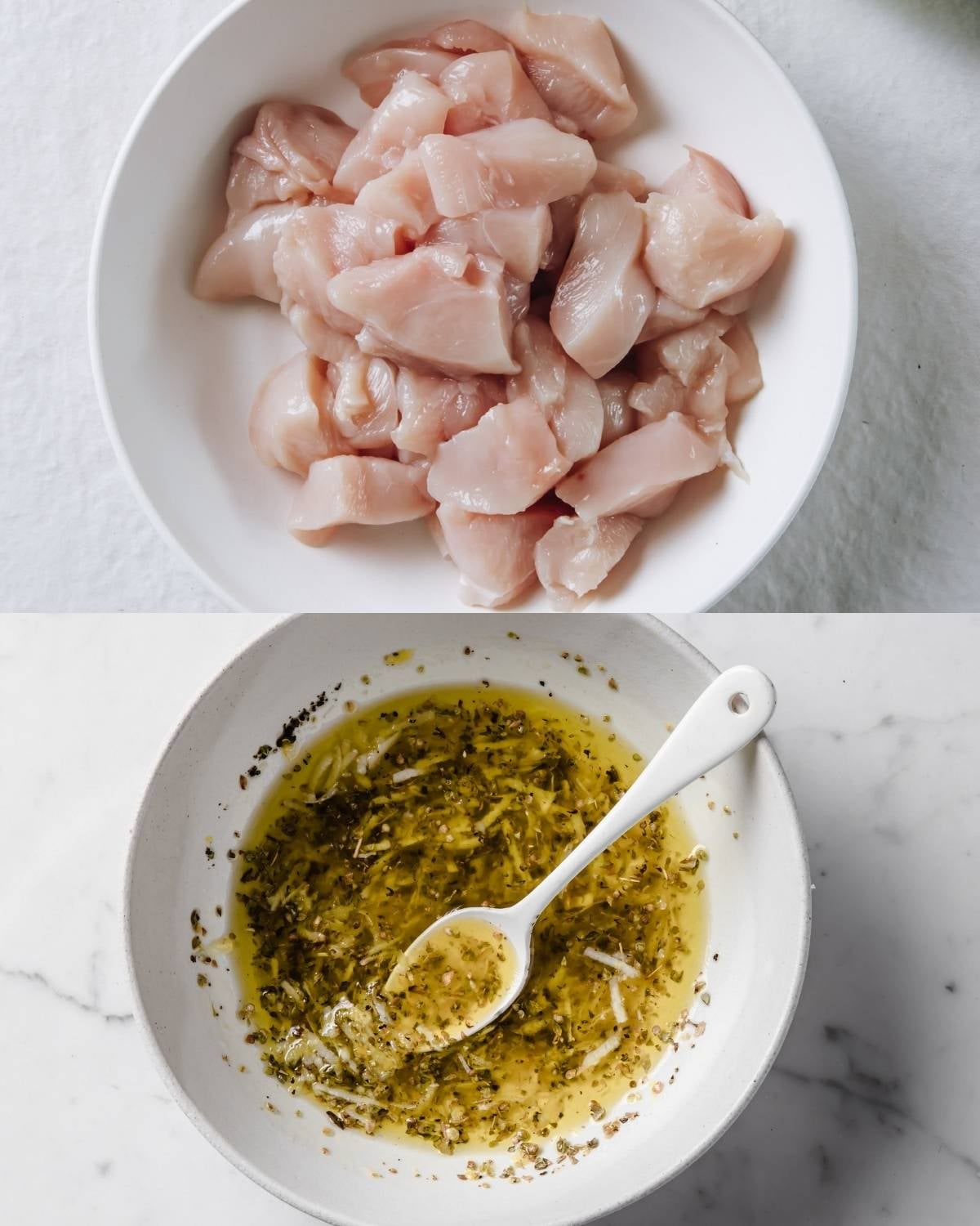 Top: A bowl filled with raw, diced chicken breast.
Bottom: A bowl of marinade made with oil, herbs, and grated garlic, with a spoon resting in it.