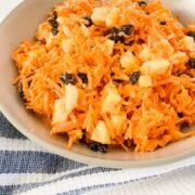 a bowl of carrot raisin salad with pineapple