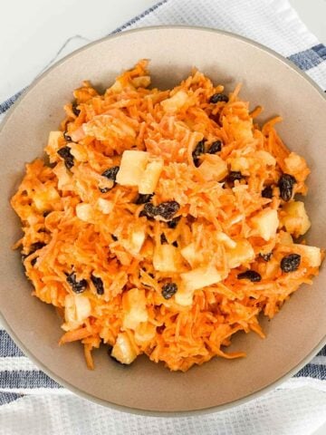 top view of a bowl of carrot raisin salad with pineapple
