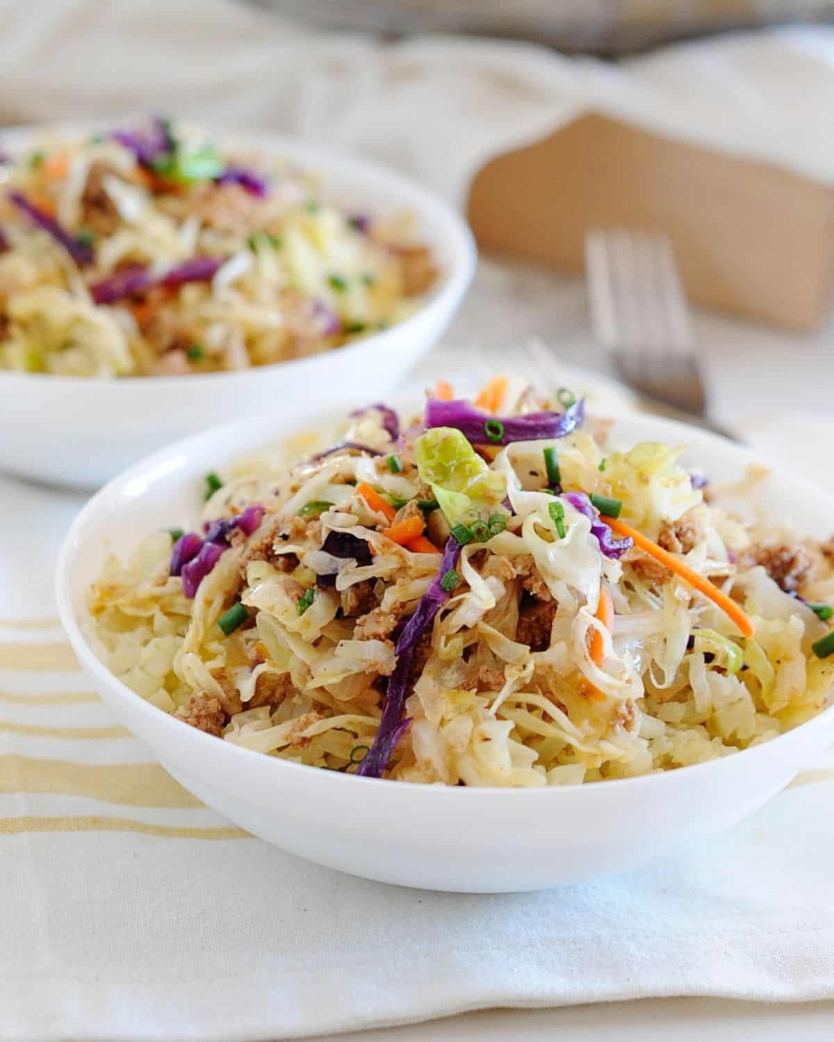 two bowls of sauteed cabbage