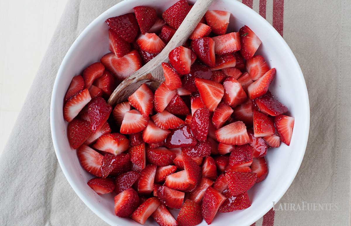 large bowl of chopped strawberries and sweetener before roasting