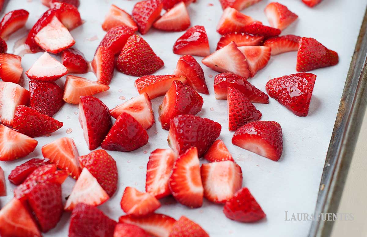 chopped strawberries on a baking sheet for roasting