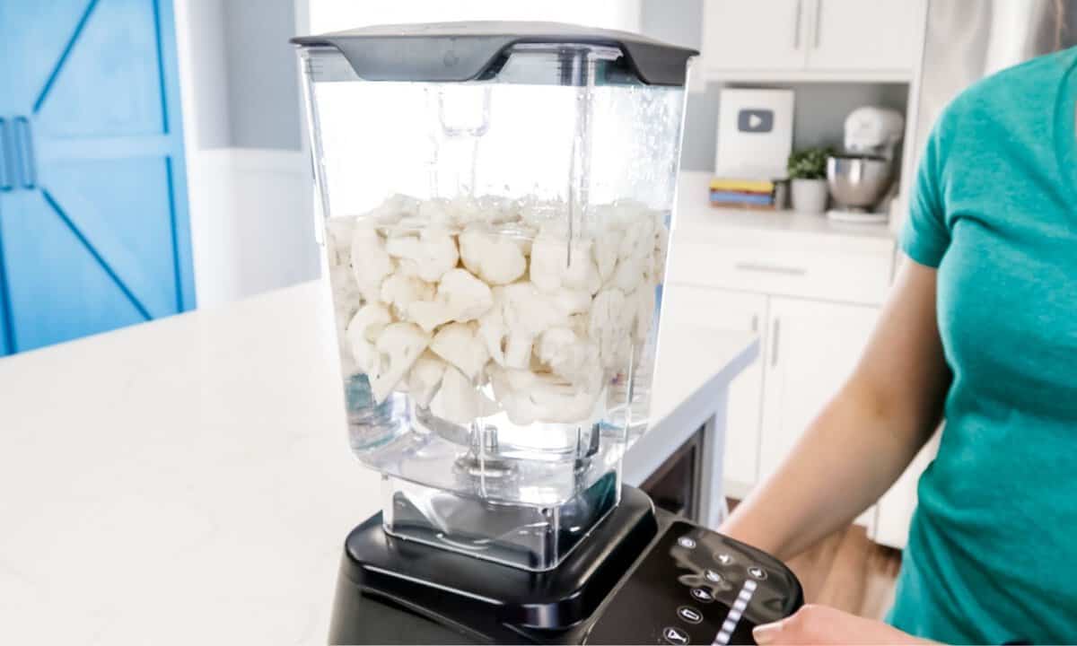 cauliflower pieces with water inside the blender