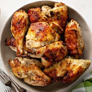 large plate of freshly baked mixed chicken pieces