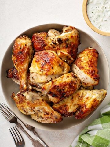 large plate of freshly baked mixed chicken pieces