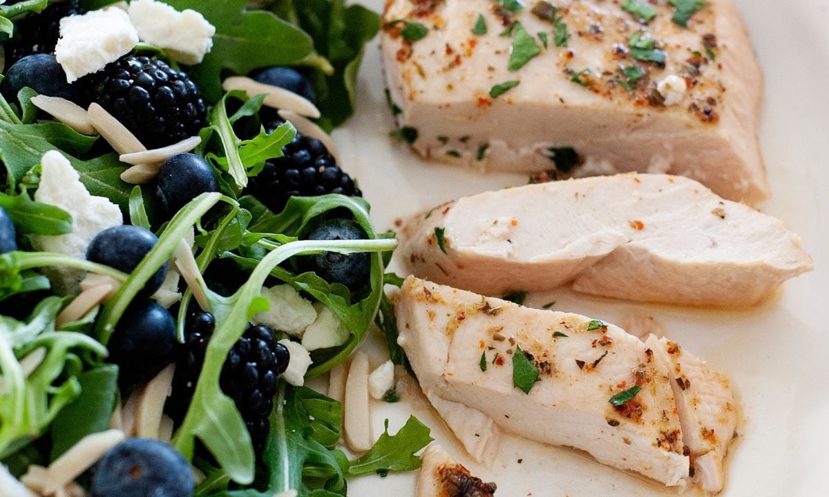 sliced chicken breast with a salad on the side