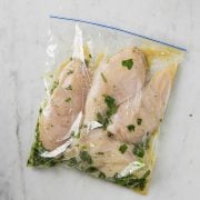 four chicken breasts in a cilantro lime marinade bag