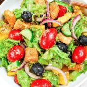 side salad with lettuce, tomato, olives, onion, and croutons