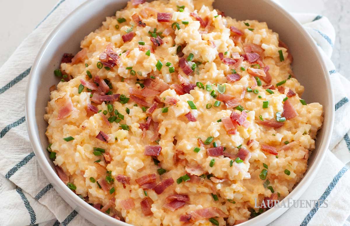 large bowl of cheesy cauliflower rice topped with bacon