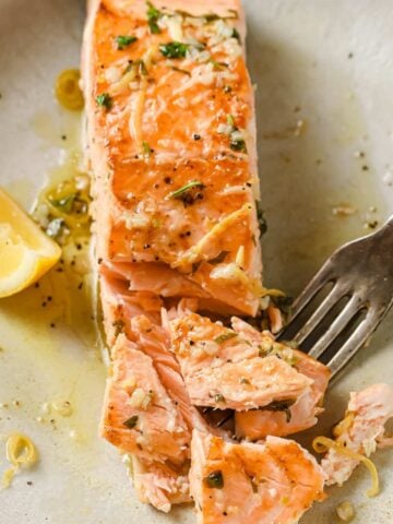 flaky salmon fillet on a plate that's been cooked in an air fryer