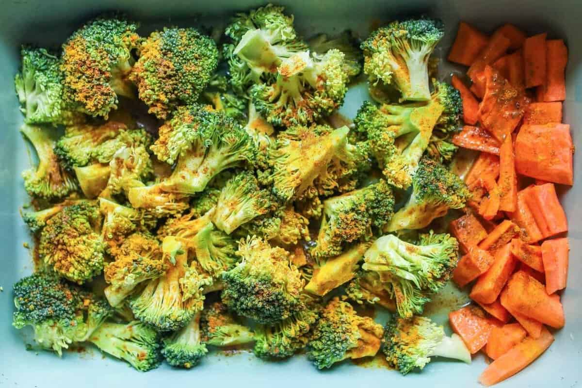overhead view of roasted broccoli and carrots in a baking dish