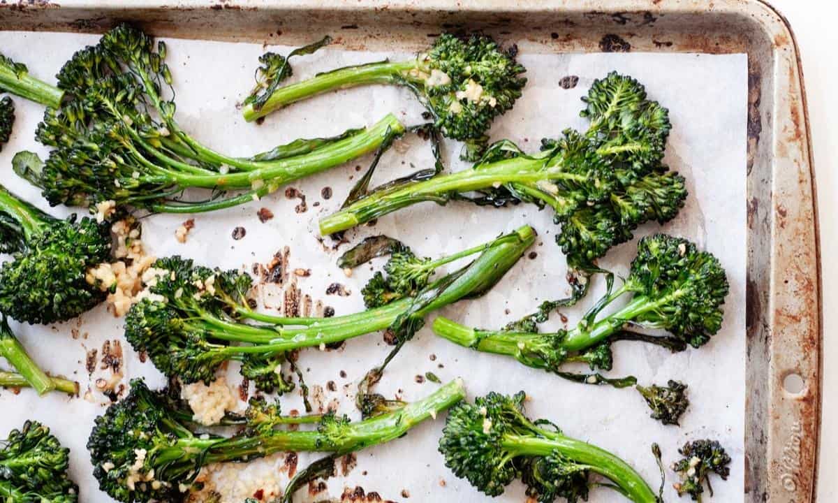 roasted broccolini in a lined baking sheet