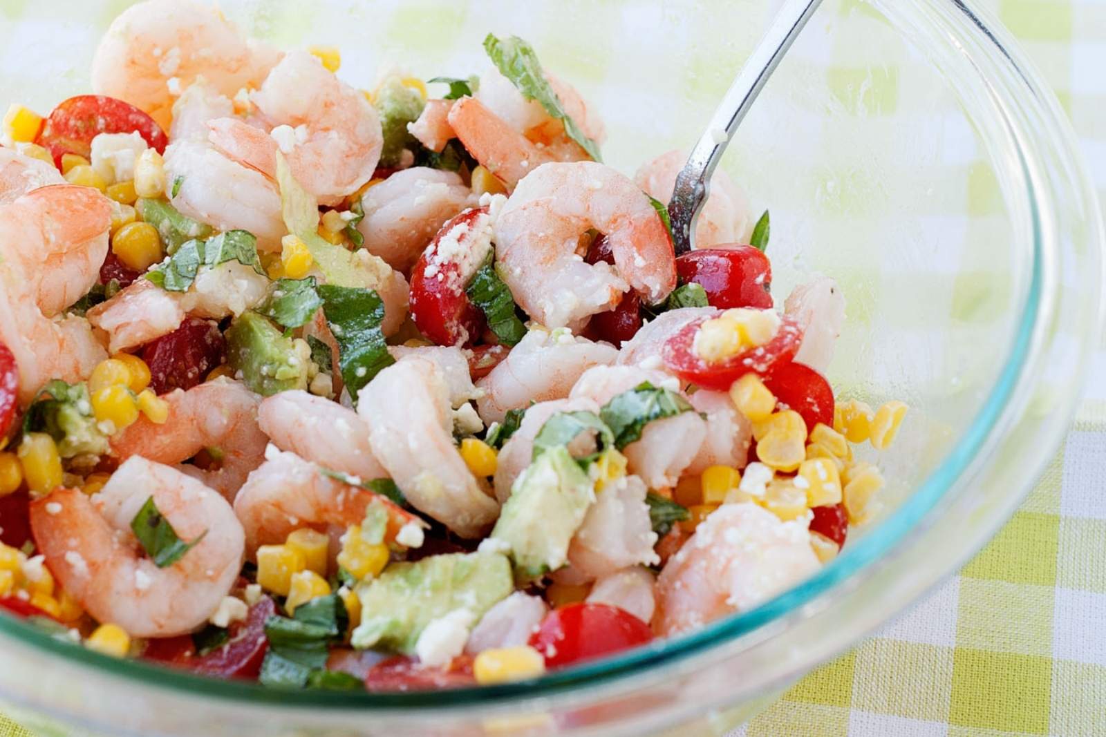 a bowl with avocado shrimp corn tomato salad