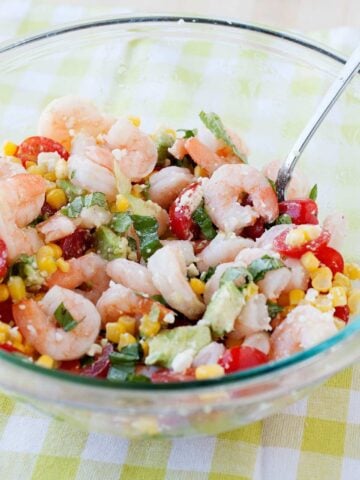 a bowl with avocado shrimp corn tomato salad