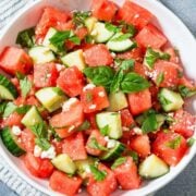 a bowl of watermelon cucumber salad with mint