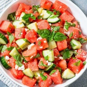 a bowl of watermelon cucumber salad with mint