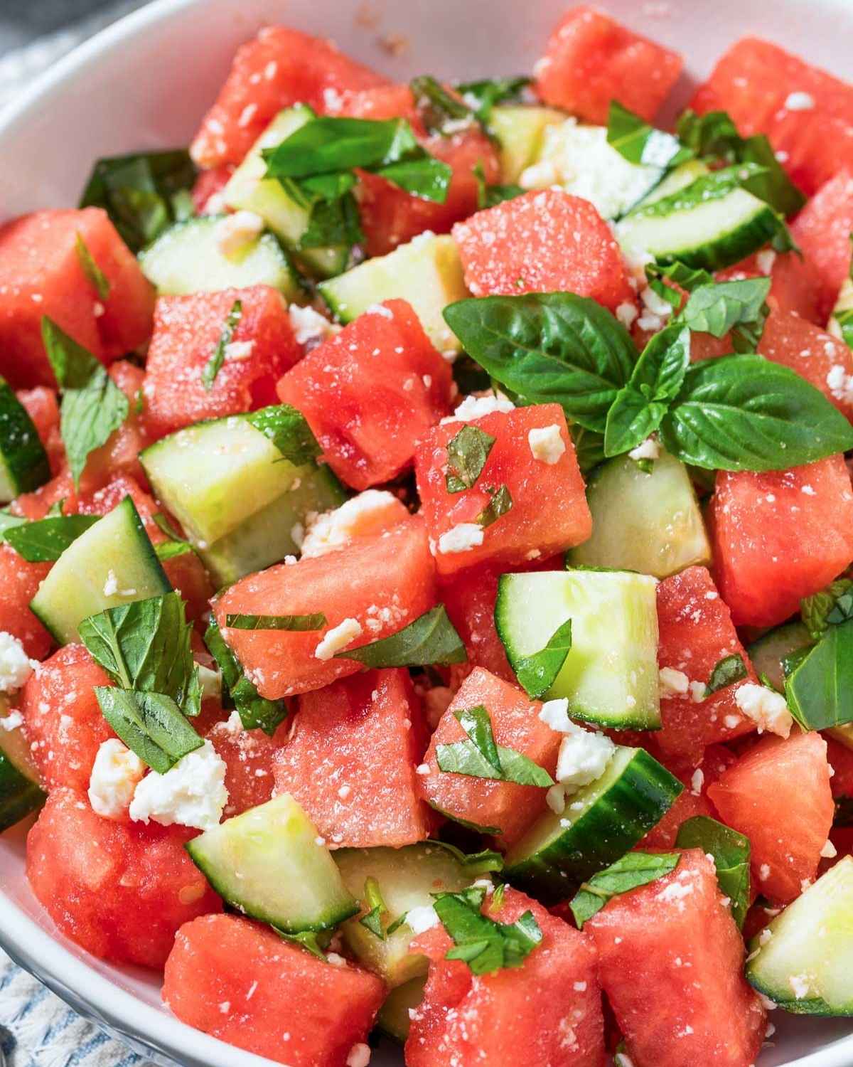 a bowl of watermelon cucumber salad witt mint