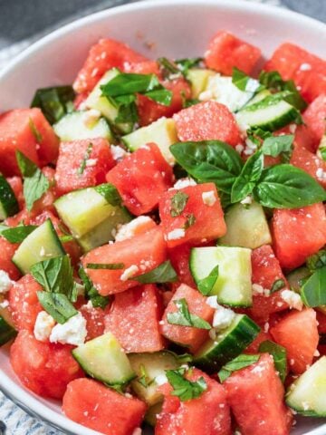 a bowl of watermelon cucumber salad with mint