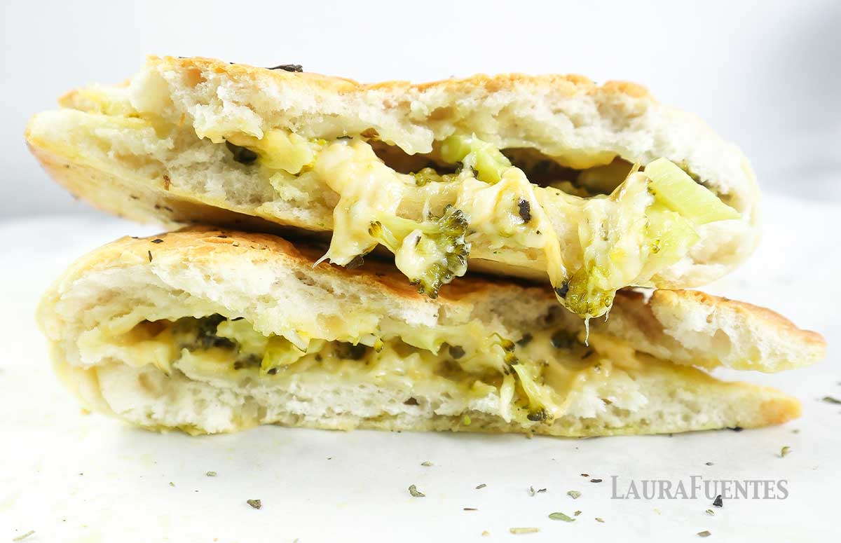 broccoli cheese calzone cut in half and stacked