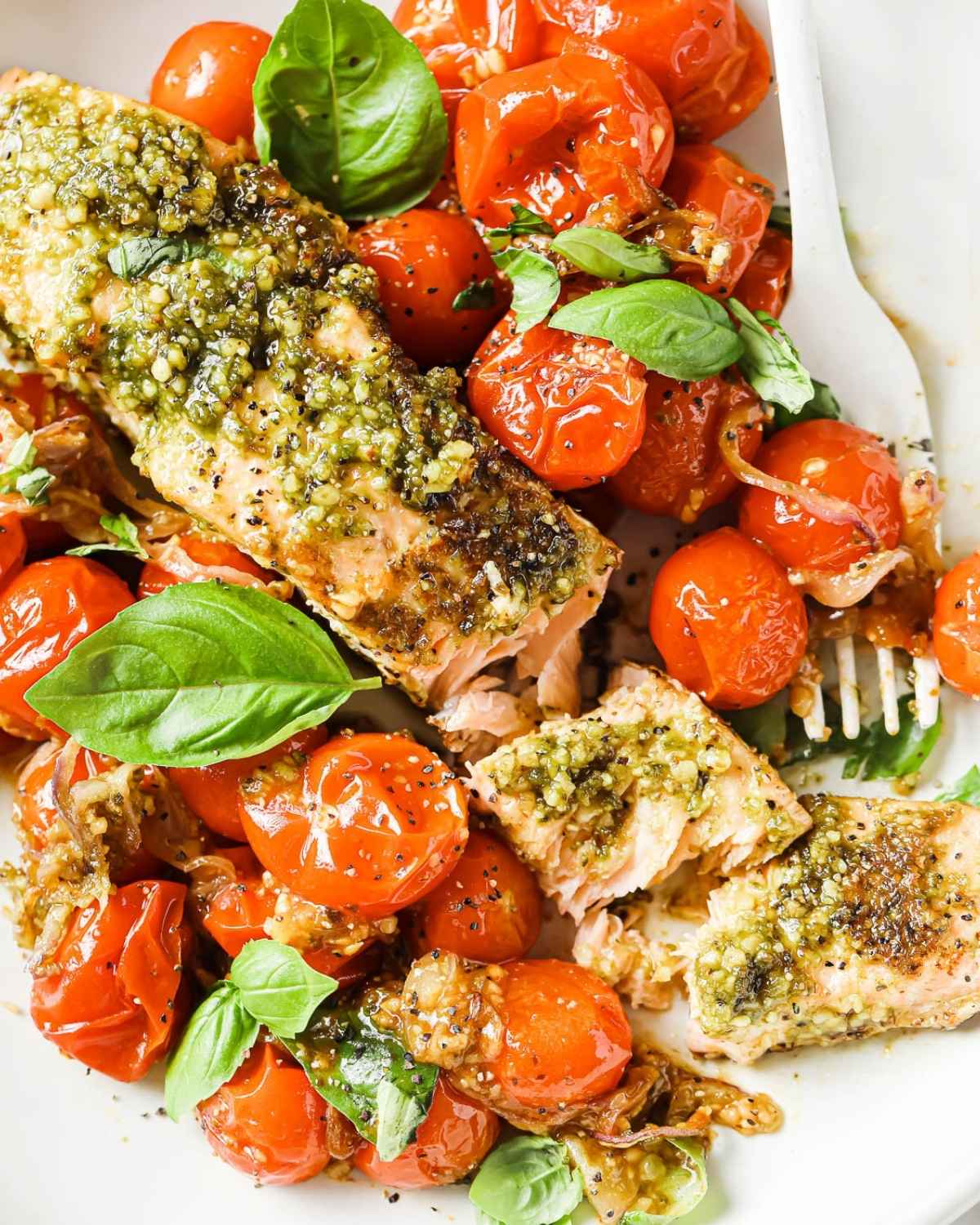 baked pesto salmon and cherry tomatoes on a plate