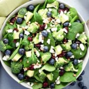 top view of blueberry spinach salad with broccoli and avocado in a large bowl
