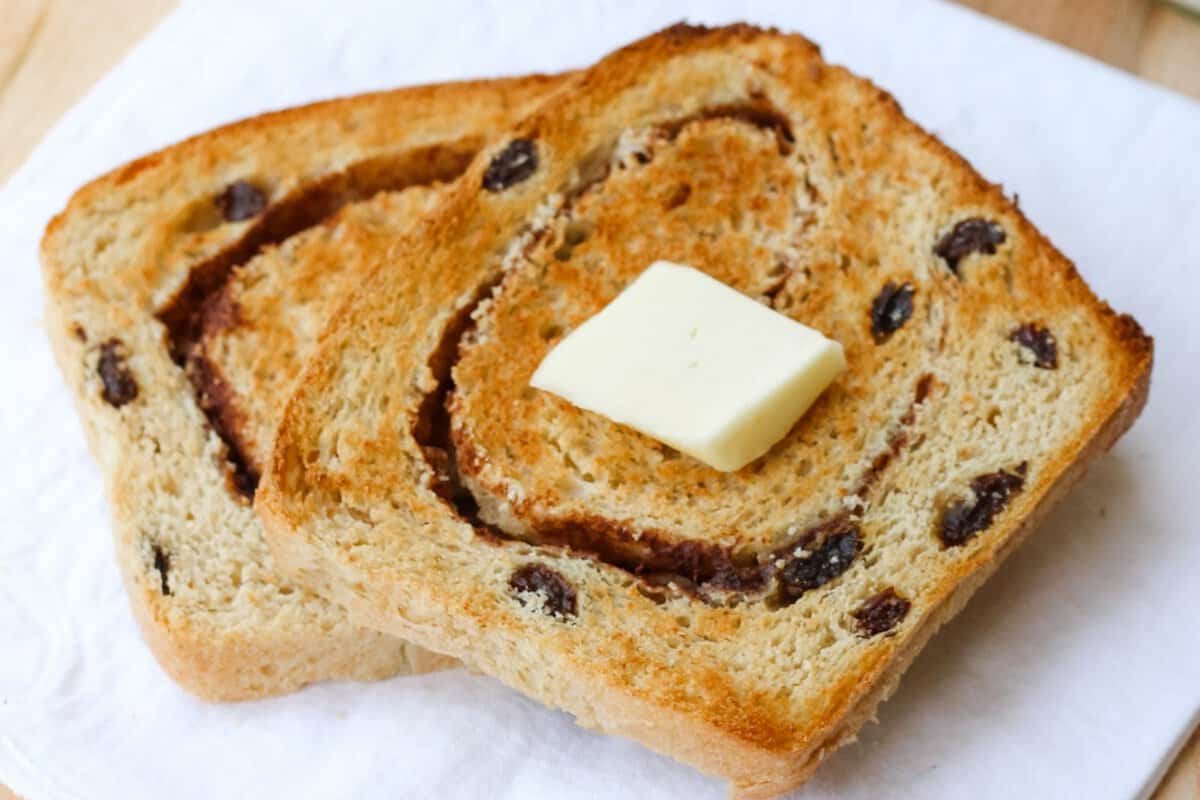 two slices of cinnamon raisin bread topped with butter