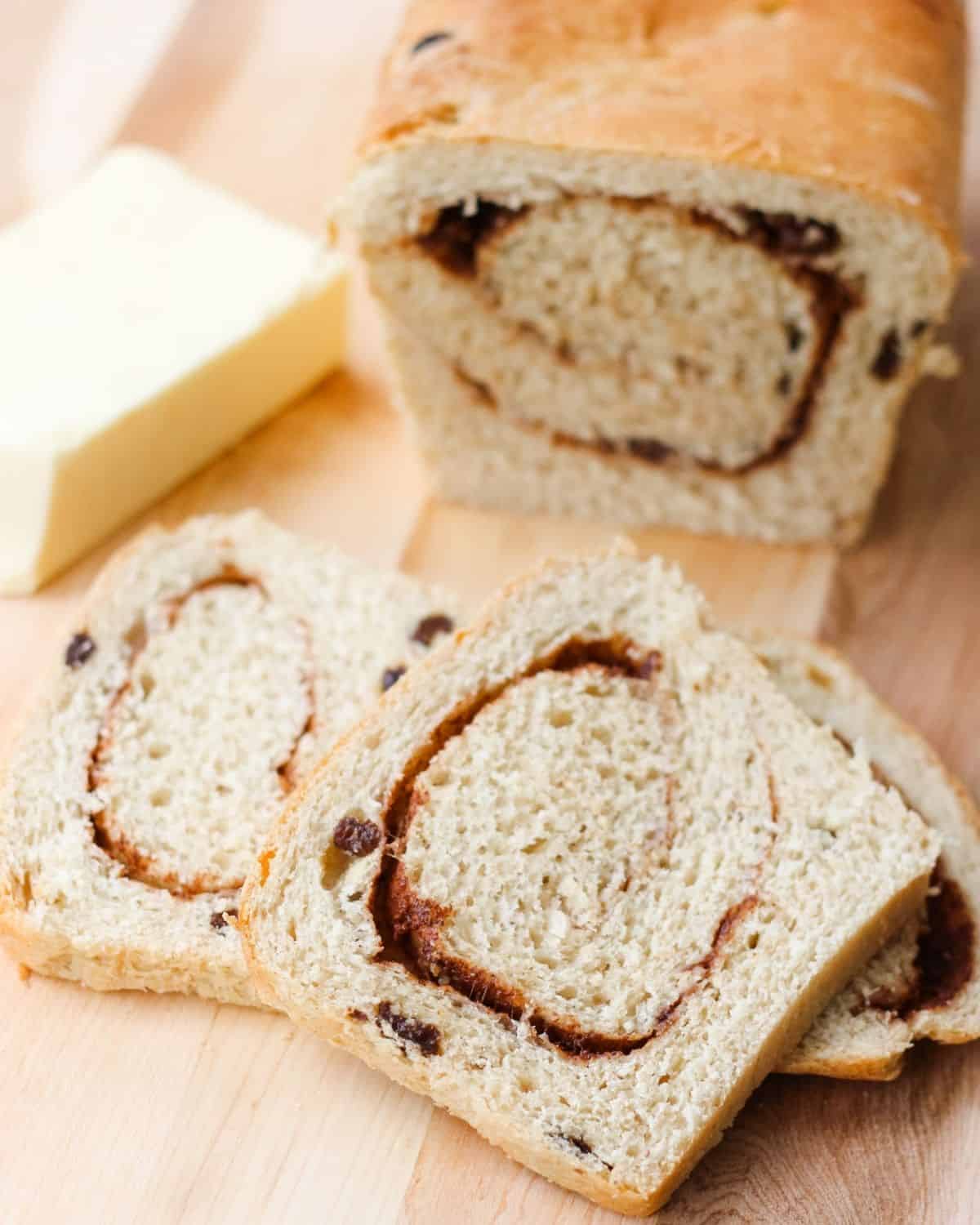 loaf of cinnamon raisin bread with two slices cut out