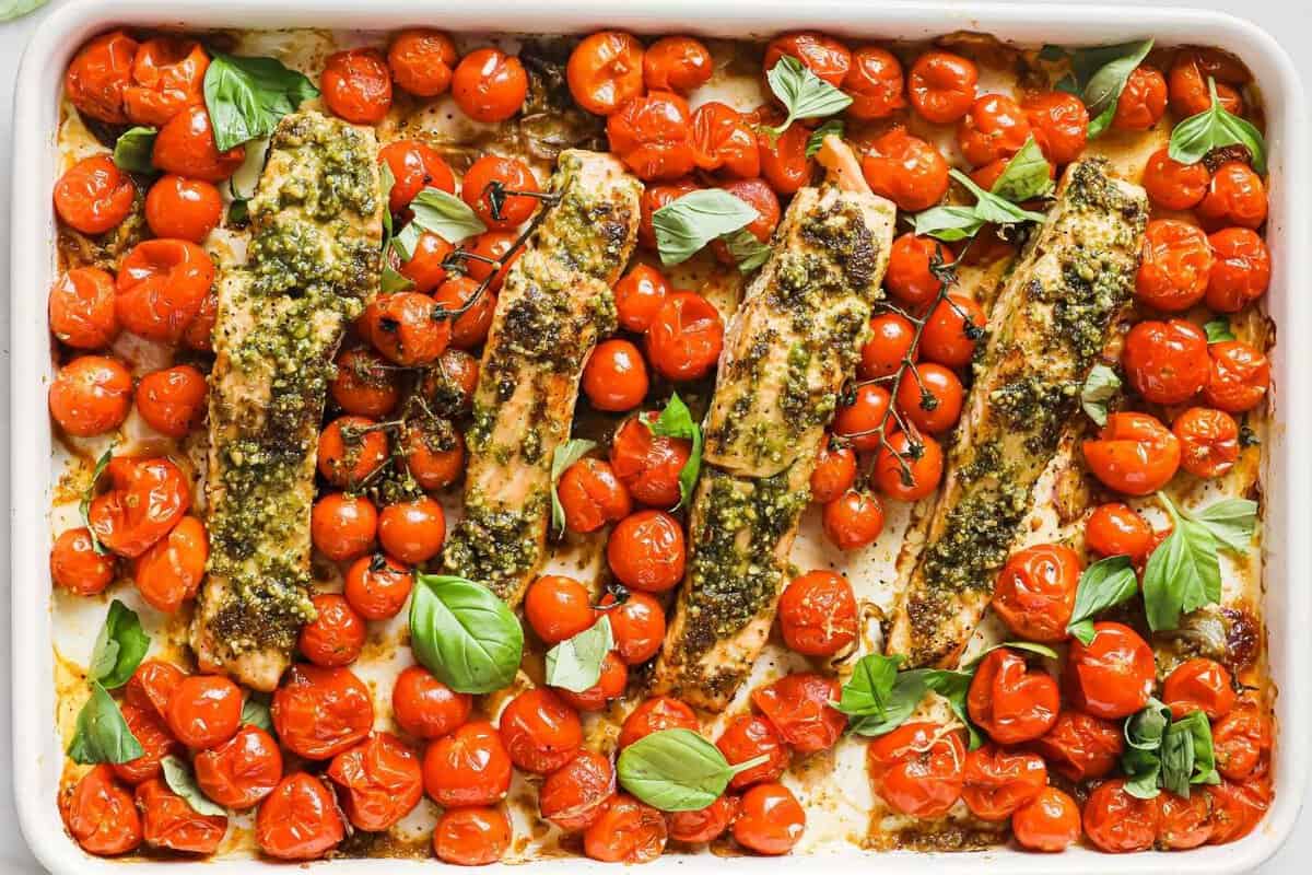large sheet pan of roasted cherry tomatoes and salmon