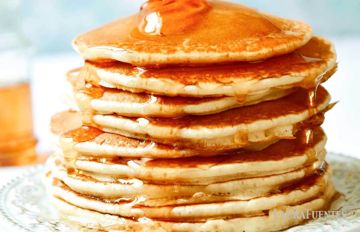 stack of rice flour pancakes on a plate with honey poured over it