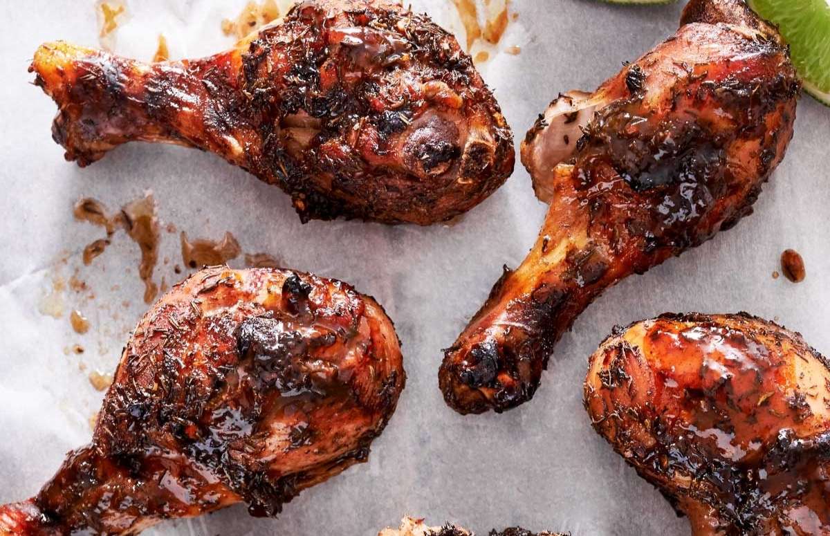 jerk chicken drumsticks on a baking sheet